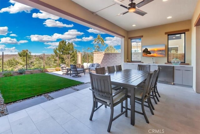 view of patio with outdoor dining area and a ceiling fan