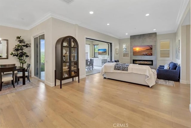 bedroom with baseboards, ornamental molding, recessed lighting, a fireplace, and light wood-style floors