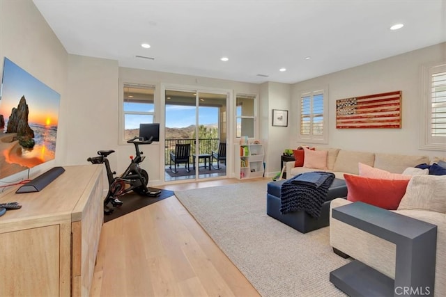 living area with visible vents, recessed lighting, baseboards, and wood finished floors