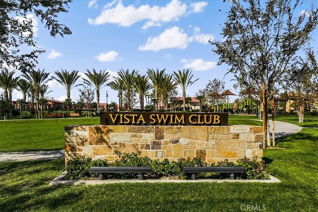 community sign featuring a lawn