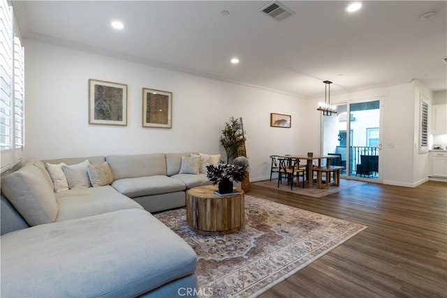 living room featuring dark wood finished floors, visible vents, recessed lighting, and crown molding