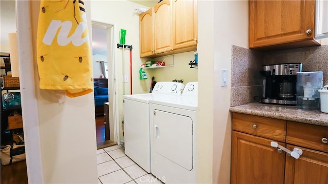 laundry room with washer and dryer, laundry area, and light tile patterned floors