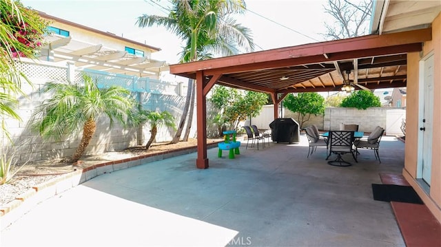 view of patio featuring outdoor dining space, a fenced backyard, and a pergola