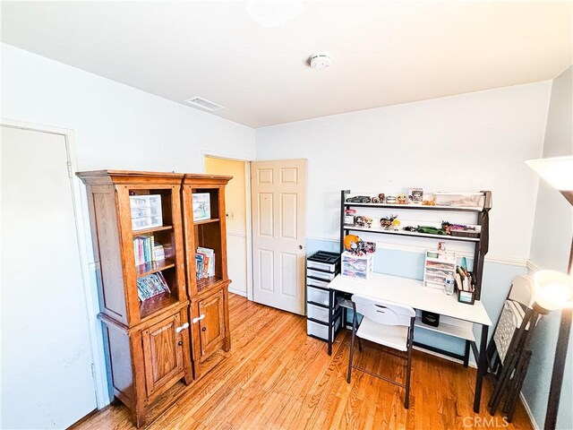 home office featuring visible vents and light wood-type flooring