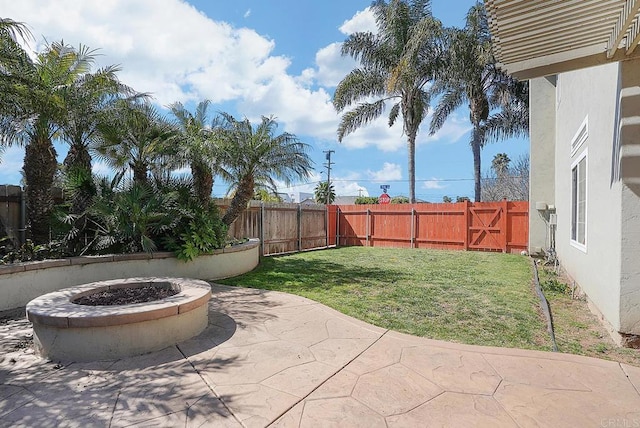 view of yard with a patio, a fire pit, and a fenced backyard