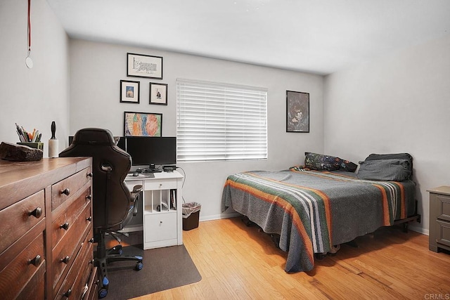 bedroom featuring light wood-style flooring and baseboards