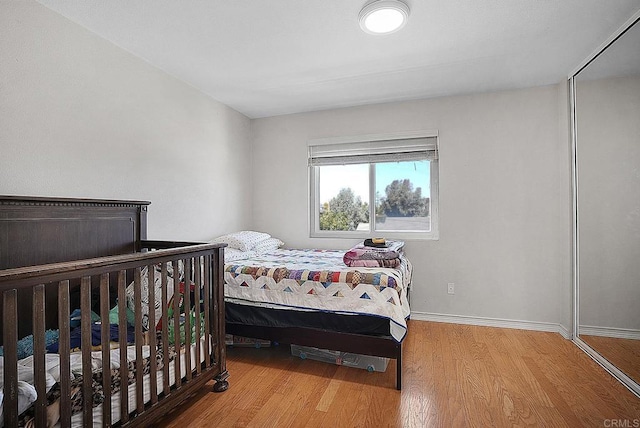 bedroom featuring baseboards and wood finished floors