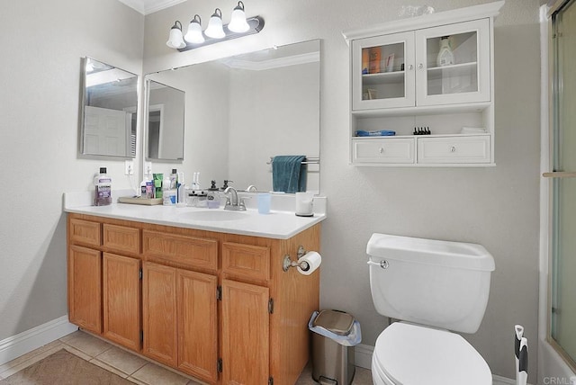 bathroom with vanity, baseboards, a shower with shower door, tile patterned floors, and toilet