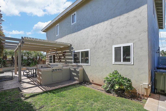 back of property featuring fence, area for grilling, a pergola, stucco siding, and a patio area