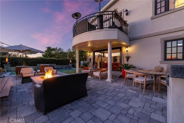 view of patio featuring a fenced in pool, an outdoor hangout area, a balcony, and outdoor dining space