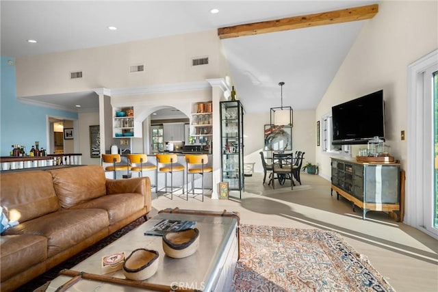 living room with beam ceiling, visible vents, and high vaulted ceiling