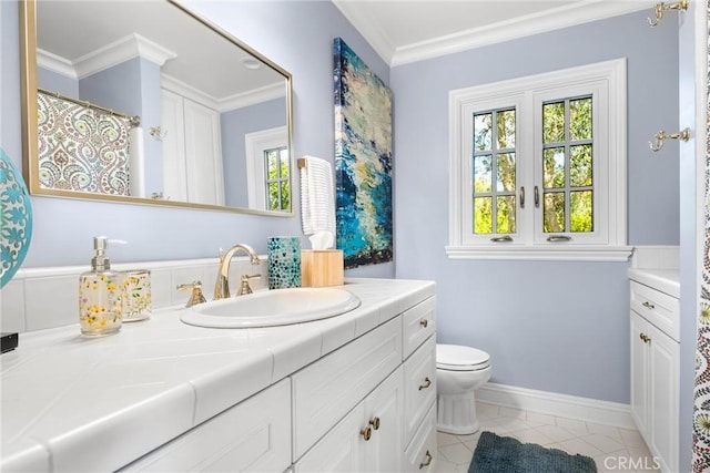 bathroom featuring baseboards, toilet, ornamental molding, tile patterned floors, and vanity