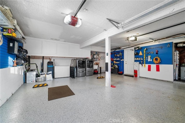 garage with a garage door opener and separate washer and dryer