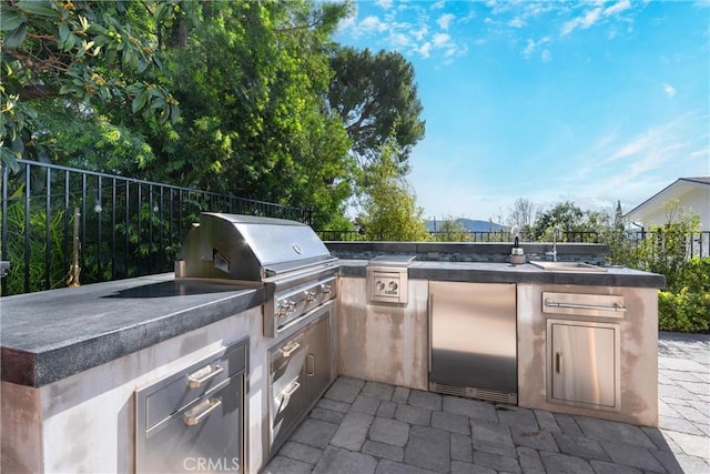 view of patio featuring a sink, area for grilling, and fence