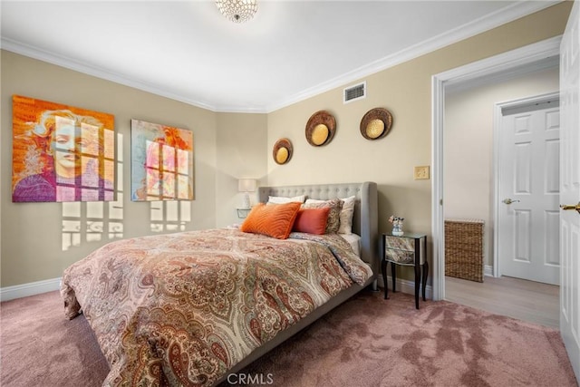 bedroom featuring visible vents, baseboards, carpet, and crown molding