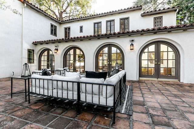 back of house featuring a patio area, stucco siding, french doors, and an outdoor hangout area