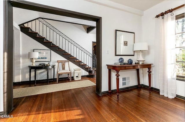 foyer with stairs, baseboards, and wood finished floors