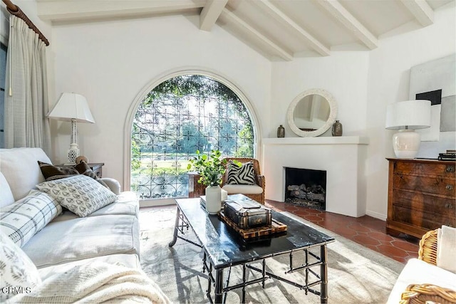 tiled living area featuring lofted ceiling with beams and a fireplace with flush hearth