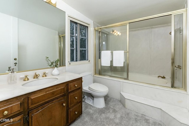 bathroom featuring vanity, toilet, and combined bath / shower with glass door