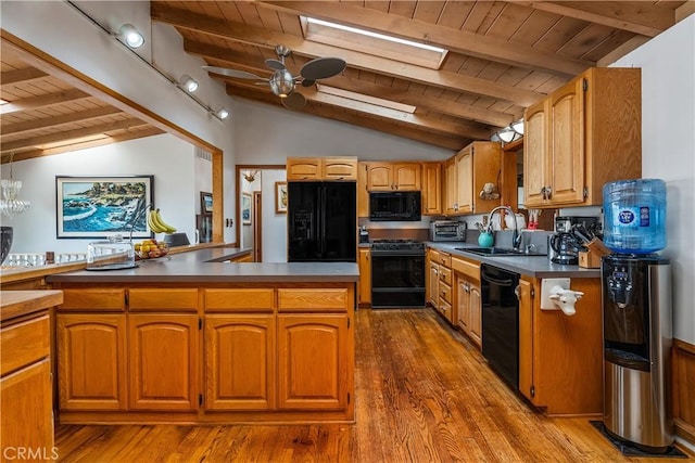 kitchen featuring black appliances, a ceiling fan, a sink, wood finished floors, and wood ceiling