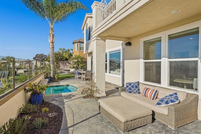 view of patio / terrace with an outdoor pool, a balcony, and fence