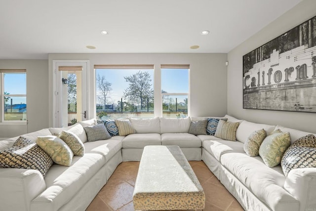 living area with recessed lighting, a healthy amount of sunlight, and tile patterned floors