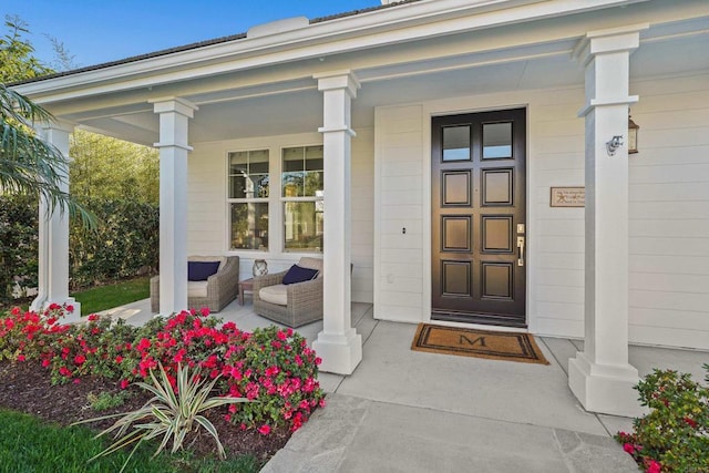 view of exterior entry with covered porch