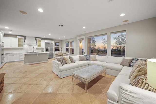 living room featuring recessed lighting and visible vents