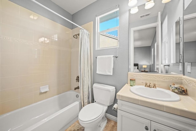 bathroom with visible vents, toilet, tasteful backsplash, shower / tub combo, and vanity