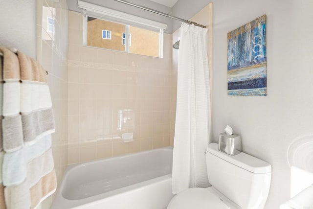 bathroom featuring toilet and shower / tub combo with curtain