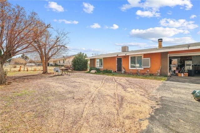 ranch-style house featuring driveway, brick siding, and an attached garage