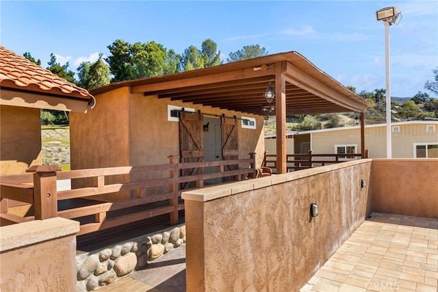 view of patio with an outbuilding and an exterior structure