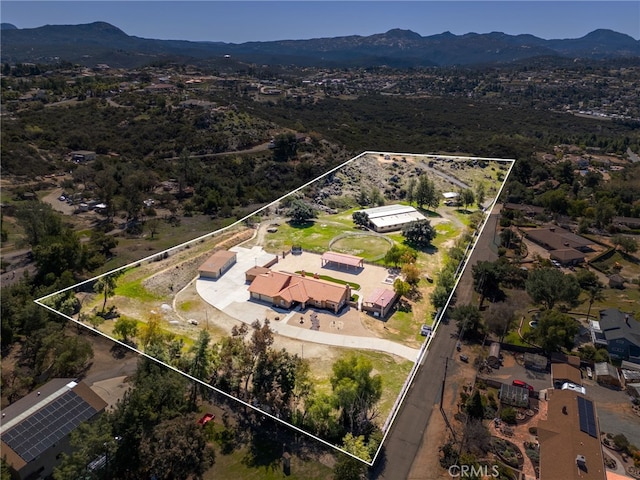 birds eye view of property with a mountain view