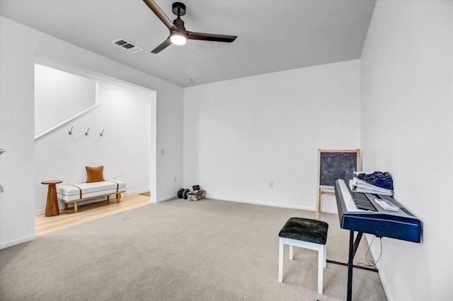 miscellaneous room featuring a ceiling fan, visible vents, carpet floors, and baseboards