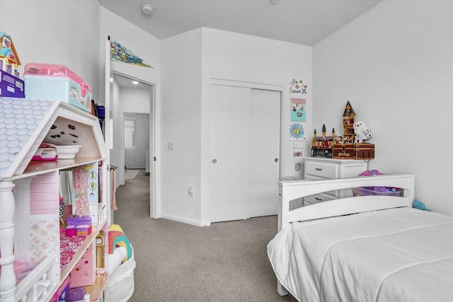 carpeted bedroom featuring a closet and baseboards