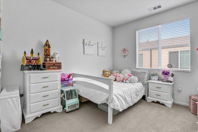 bedroom with visible vents, light carpet, and baseboards