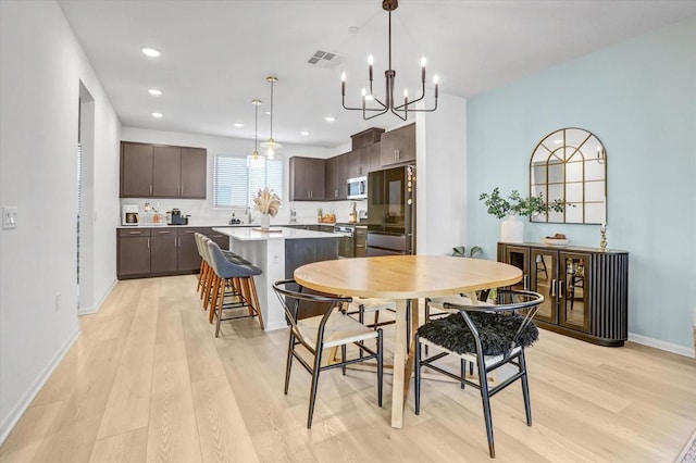 dining area featuring recessed lighting, baseboards, visible vents, and light wood-type flooring