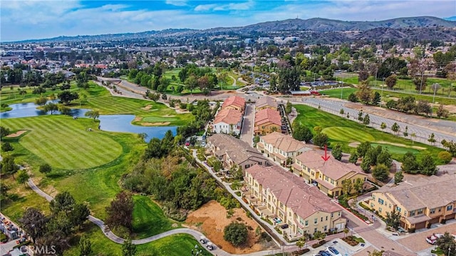 aerial view with view of golf course, a residential view, and a water and mountain view