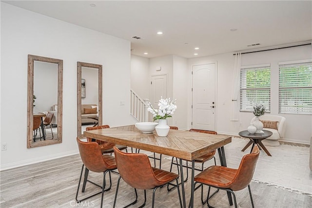 dining room with recessed lighting, stairway, light wood-style flooring, and visible vents