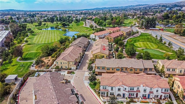 drone / aerial view with a residential view, a water view, and view of golf course