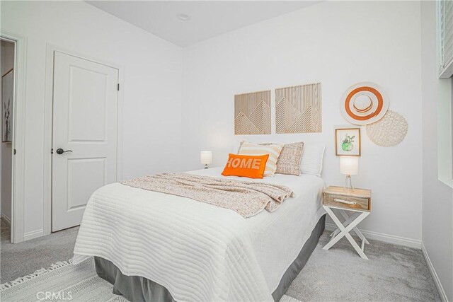 bedroom with carpet and baseboards