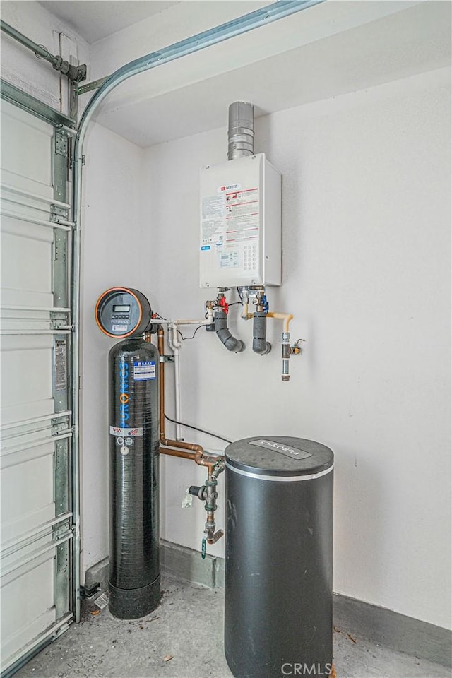 utilities featuring tankless water heater and a garage