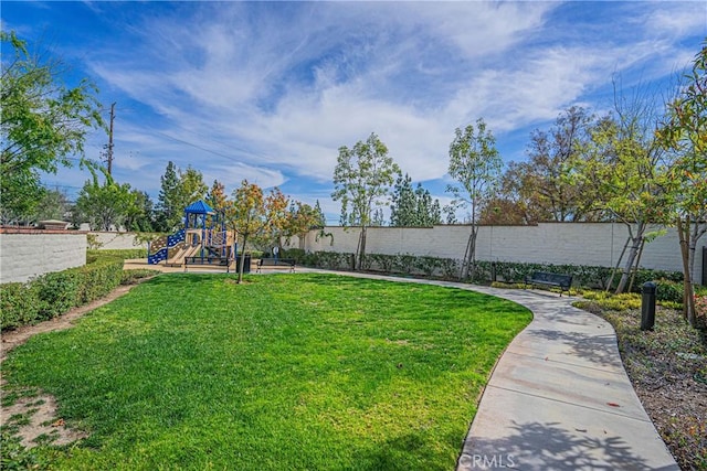 view of yard with playground community and fence