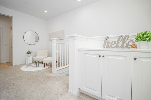 hall featuring recessed lighting, light colored carpet, and baseboards