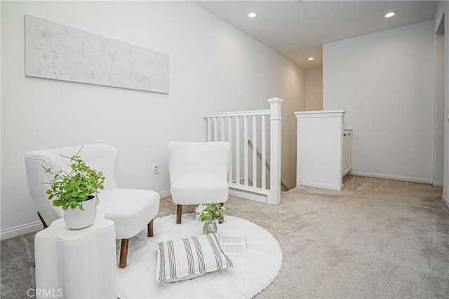 living area with an upstairs landing, carpet flooring, recessed lighting, and baseboards