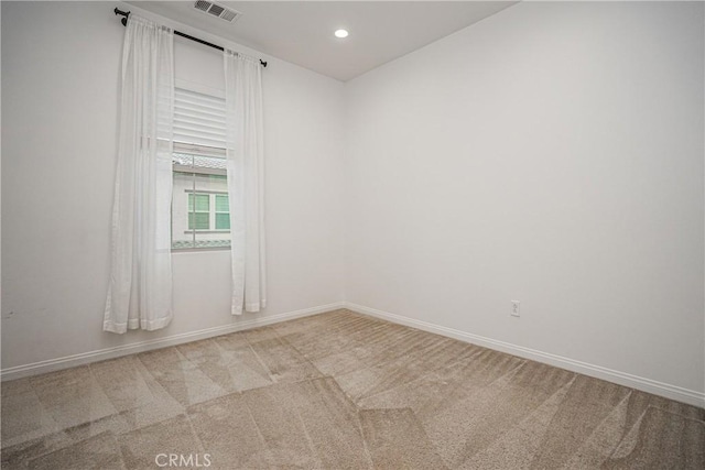 carpeted empty room featuring visible vents, recessed lighting, and baseboards