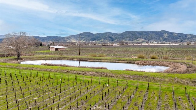 view of mountain feature with a rural view and a water view