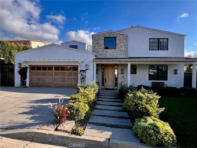 view of front facade featuring stucco siding, stone siding, driveway, and an attached garage