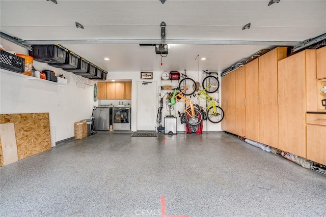 garage featuring a garage door opener and washing machine and dryer