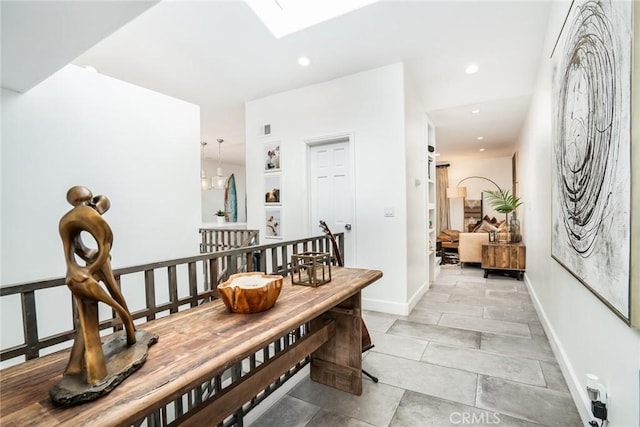 dining room with recessed lighting, baseboards, and a skylight